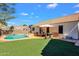Backyard with a private pool, artificial grass, and desert landscaping at 823 W Kyle Ct, Gilbert, AZ 85233