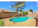 Backyard pool with artificial turf, patio, and shade tree for relaxation at 823 W Kyle Ct, Gilbert, AZ 85233