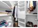 Organized walk-in closet with ample shelving, hanging rods, and space for luggage at 823 W Kyle Ct, Gilbert, AZ 85233