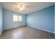 Bright bedroom with wood floors, a window with shutters, and light-blue colored walls at 8303 E Monterey Ave, Mesa, AZ 85209