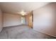 Large bedroom with neutral carpet and a ceiling fan at 8303 E Monterey Ave, Mesa, AZ 85209