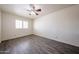 Bright bedroom with wood floors, a window with shutters, and a ceiling fan at 8303 E Monterey Ave, Mesa, AZ 85209