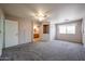 Large primary bedroom featuring neutral carpet, en-suite bathroom, and ample space at 8303 E Monterey Ave, Mesa, AZ 85209