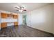 Bedroom with built-in desk and cabinets, wood floors, and ceiling fan at 8303 E Monterey Ave, Mesa, AZ 85209