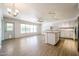 Bright kitchen and dining area featuring modern white cabinets, island, wood floors and ample natural light at 8303 E Monterey Ave, Mesa, AZ 85209