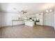 Spacious kitchen with stainless steel appliances, white cabinetry, and an eat-in island at 8303 E Monterey Ave, Mesa, AZ 85209