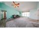 Comfortable living room with a fan, neutral walls and plush carpeting, perfect for relaxation at 8303 E Monterey Ave, Mesa, AZ 85209
