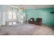 Open-concept living space with cool-toned walls, fan, carpet, and views to a bright dining area at 8303 E Monterey Ave, Mesa, AZ 85209