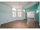 Open-concept room with stylish light fixture, front door, and wood-look flooring at 8303 E Monterey Ave, Mesa, AZ 85209