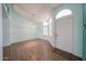 Inviting room with wood floors, plantation shutters, light walls, and a bright front door at 8303 E Monterey Ave, Mesa, AZ 85209
