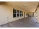 Covered patio with brick walls, recessed lighting, and ample space for outdoor seating at 8303 E Monterey Ave, Mesa, AZ 85209