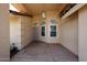 Charming front porch with tiled flooring, textured walls, and a decorative hanging light fixture at 8303 E Monterey Ave, Mesa, AZ 85209