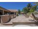 Backyard featuring a stone patio, outdoor kitchen, and fire pit at 9412 S Palm Dr, Tempe, AZ 85284