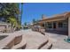 Spacious backyard featuring a pool with a waterfall, outdoor kitchen, and stone patio at 9412 S Palm Dr, Tempe, AZ 85284