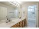 Bathroom boasts double sinks, a large mirror, and tile flooring at 9412 S Palm Dr, Tempe, AZ 85284