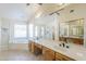 Bathroom with double sinks, large mirror, and soaking tub, providing a luxurious experience at 9412 S Palm Dr, Tempe, AZ 85284