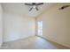 Simple bedroom with a ceiling fan provides ample space and access to the outdoors at 9412 S Palm Dr, Tempe, AZ 85284