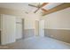 Bedroom features carpet, neutral walls, closet space, and fan at 9412 S Palm Dr, Tempe, AZ 85284