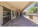 Covered patio with flagstone flooring, ceiling fan, and a built-in outdoor kitchen area at 9412 S Palm Dr, Tempe, AZ 85284