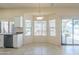 Bright dining area features bay window, a hanging light fixture, and kitchen bar at 9412 S Palm Dr, Tempe, AZ 85284
