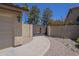 Driveway leading to a gate, next to a stucco home and three-car garage at 9412 S Palm Dr, Tempe, AZ 85284