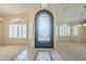 Elegant entryway features an ornate iron door, tile accents, and plantation shutters for a bright, welcoming space at 9412 S Palm Dr, Tempe, AZ 85284