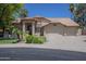 Beautiful home with a three-car garage, tile roof, and meticulously kept landscaping at 9412 S Palm Dr, Tempe, AZ 85284