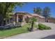 Charming home with a well-manicured lawn, mature trees, and a three-car garage at 9412 S Palm Dr, Tempe, AZ 85284