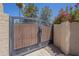 Close-up of entry gate with decorative iron accents and a stucco wall at 9412 S Palm Dr, Tempe, AZ 85284