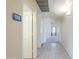 Hallway with tile floors, leading to bedrooms and living spaces with convenient thermostat access at 9412 S Palm Dr, Tempe, AZ 85284