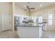 Bright kitchen features white cabinets, stainless steel appliances, and center island at 9412 S Palm Dr, Tempe, AZ 85284