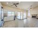 Open kitchen features white cabinets, stainless appliances, and island with tile floors that connects to fireplace at 9412 S Palm Dr, Tempe, AZ 85284