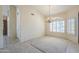 Inviting living room with tile flooring, plantation shutters, and a decorative chandelier at 9412 S Palm Dr, Tempe, AZ 85284