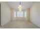 Bright living area featuring arched windows with plantation shutters and unique pendant lighting at 9412 S Palm Dr, Tempe, AZ 85284