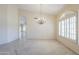 Bright living room features tile flooring, a decorative chandelier, and an arched doorway at 9412 S Palm Dr, Tempe, AZ 85284