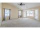 Spacious living room with carpet, natural light, and a ceiling fan at 9412 S Palm Dr, Tempe, AZ 85284