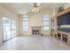 Open-concept living room featuring a fireplace and sliding glass door to the pool area at 9412 S Palm Dr, Tempe, AZ 85284