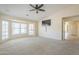 Large living room has plenty of natural light, ceiling fan, and wall-mounted TV at 9412 S Palm Dr, Tempe, AZ 85284