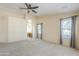 Spacious main bedroom features a ceiling fan and large windows, offering natural light and comfort at 9412 S Palm Dr, Tempe, AZ 85284