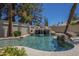 Backyard pool featuring a rock waterfall, lush greenery, and a tranquil ambiance at 9412 S Palm Dr, Tempe, AZ 85284