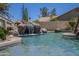 Beautiful backyard pool with a captivating rock waterfall feature, creating a serene atmosphere at 9412 S Palm Dr, Tempe, AZ 85284