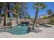 Captivating swimming pool with a rock waterfall, surrounded by mature trees and beautiful landscaping at 9412 S Palm Dr, Tempe, AZ 85284
