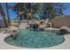 Beautiful outdoor pool with a rock waterfall, mature trees, and a serene atmosphere at 9412 S Palm Dr, Tempe, AZ 85284