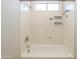 Clean white shower-tub combination with built-in shelving at 9412 S Palm Dr, Tempe, AZ 85284