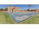 Outdoor basketball court with well-maintained surface and hoops, surrounded by grass and greenery at 1133 N 84Th Pl, Scottsdale, AZ 85257