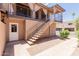 Building exterior featuring staircase access, a garage and well-maintained landscaping at 1133 N 84Th Pl, Scottsdale, AZ 85257