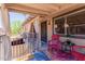 Charming covered patio area featuring a comfortable seating area and colorful outdoor rug at 1133 N 84Th Pl, Scottsdale, AZ 85257