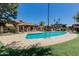 Community pool surrounded by lush greenery and comfortable lounge chairs for relaxation at 1133 N 84Th Pl, Scottsdale, AZ 85257