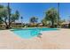 Community pool surrounded by lush greenery and comfortable lounge chairs for relaxation at 1133 N 84Th Pl, Scottsdale, AZ 85257