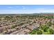 An aerial view of a neighborhood with well-maintained homes, mature trees, and blue sky in the background at 1145 E Winchester Pl, Chandler, AZ 85286